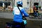 Ho Chi Minh, Vietnam â€“ December 18, 2017: Uber delivery man on a motorbike waiting custumer on the street, Saigon