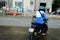 Ho Chi Minh, Vietnam â€“ December 18, 2017: Uber delivery man on a motorbike waiting custumer on the street, Saigon