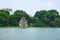 Ho Hoan Kiem, the little lake in the old part of Hanoi, Vietnam, with the Tortoise Tower. Tortoise Tower is the symbol of