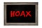 Hoax conept word on a chalkboard background. Chalkboard with danger sign with words Internet Hoax, Danger of Internet Hoax.