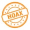 HOAX text on orange grungy vintage round stamp