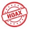 HOAX text on red grungy vintage round stamp
