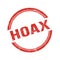 HOAX text written on red grungy round stamp