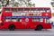 Hobart, Tasmania, Australia - December 14, 2009: Red double deck public bus with large advertisement poster, parked along street