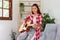 Hobby concept, Young asian woman learning and practice playing chords with acoustic guitar on couch