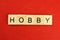 Hobby word of wooden letters on a red background