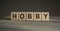 HOBBY word written on wood block. Concept for your design