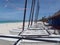 Hobie Cat sail boats line up on white sandy beach