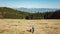 Hochanger - Hiker couple on golden alpine meadow of mount Hochanger, Bruck an der Mur, Lavanttal Alps, Styria, Austria