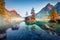 Hochkalter peak reflected in the calm waters of Hintersee lake, Germany.