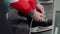 Hockey player laces skate sitting on bench close view