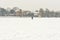 Hockey player trains alone on a frozen lake in heavy snow. people are not visible due to snow blur.