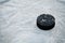 Hockey puck on ice hockey rink