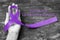 Hodgkin`s lymphoma and testicular cancer awareness violet ribbon symbolic bow color on helping hand support isolated