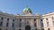 Hofburg complex building facade with dome, hyperlapse in Michaelerplatz, a major square in the center of Vienna city.