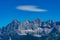 Hohe Dachstein mountain range in Austria and a white soft cloud