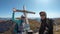 Hohe Weichsel - Couple standing in front of a wooden cross on top of Hohe Weichsel, Alpine peak in Austria. The cross is leaning