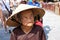 Hoi An, Vietnam - NOVEMBER 02, 2011: An elderly Vietnamese woman in a traditional straw hat