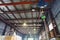 Hoist with overhead crane and scales in warehouse