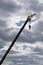 Hoisting crane at a construction site against a cloudy sky