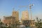 Hoisting crane and new multi-storey building. ndustrial background. Construction of high-rise houses and hoisting tower cranes. Ne