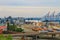 Hoisting cranes, transport containers and granaries at cargo sea port in Odessa, Ukraine