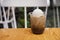Hojicha latte float drink on wooden table.