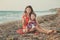 Hokum tender scene of beautiful adorable young mother enjoy life time summer vacation with her little baby girl daughter on sand b