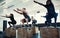 Hold it. a focused group of young people doing lunges on crates as exercise inside of a gym.