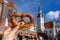 holding bayern style pretzel on the victuals market with altes rathaus background in munich