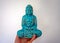 Holding a blue buddha meditating