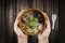 holding bowl Homemade noodle Vietnam food, Traditional Vietnamese soup and rice pudding on a wooden background, pork noodle rice