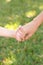 Holding childs hands in grass