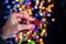 Holding Christmas glittery star decoration  on background with blurred lights. December season, Christmas composition