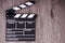 Holding clapper board or slate film concept On wooden table.