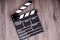 Holding clapper board or slate film concept On wooden table.