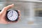 Holding clock on blurred background The time 8:00 am or pm and n