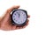 Holding clock on isolated background The time 12:00 am or pm and