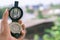 Holding compass on blurred background. Using wallpaper or background travel or navigator image