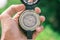 Holding compass on blurred background. Using wallpaper or background travel or navigator image