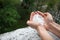 Holding freezing granulated hail ice crystals, grains in hands after strong hailstorm in autumn, fall.