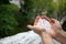 Holding freezing granulated hail ice crystals, grains in hands after strong hailstorm in autumn, fall.