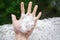 Holding freezing granulated hail ice crystals, grains in hands after strong hailstorm in autumn, fall.