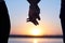 Holding hands at the beach. Silhouette couple at sunrise holding their hands in romantic scene