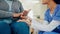 Holding hands, old woman in wheelchair and caregiver with senior care, talk and homecare in living room. Retirement