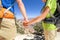 Holding hands romantic couple hiking Grand Canyon