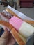 Holding ice cream sandwich bread. Neapolitan ice cream inside the bread. Three separate flavors arranged side by side.