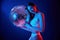 Holding mirrored ball in the club. Young woman in underwear is in the studio with neon lights