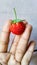 Holding sweet tiny miny strawberry