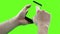 Holding touchscreen device, close-up of male hand using a smart phone with chroma key, green screen on background
